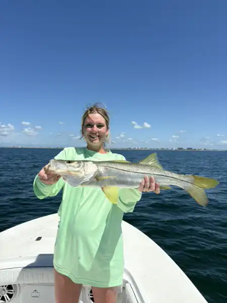 Angler holding a snook caught while fishing in Sarasota, Florida